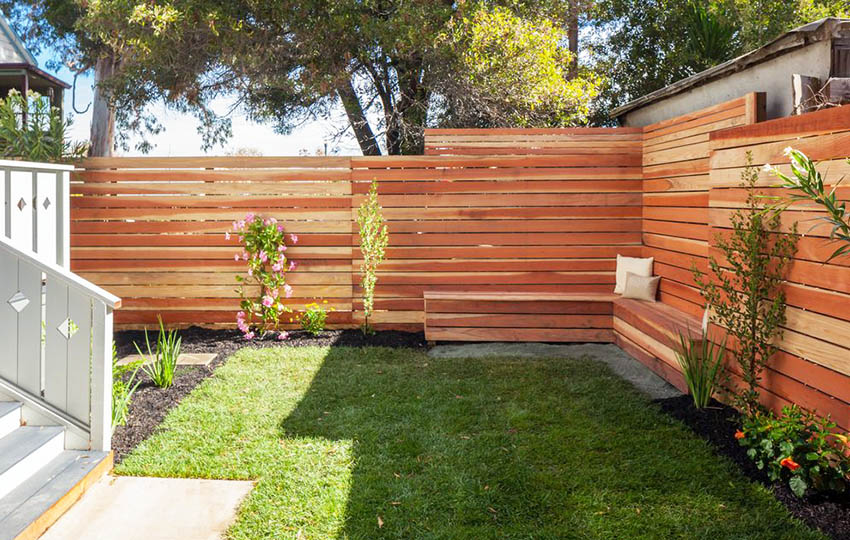 Privacy fence with horizontal design and wood sitting bench