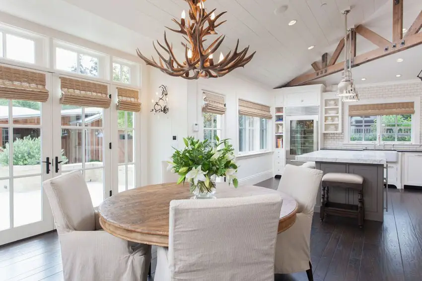 Cottage dining and kitchen space with antler chandeliers