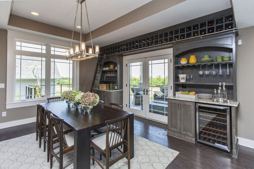 Dining room with contemporary french doors and home bar with wine storage
