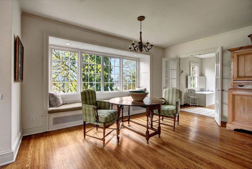 Dining room with french doors and custom window seat with picture windows