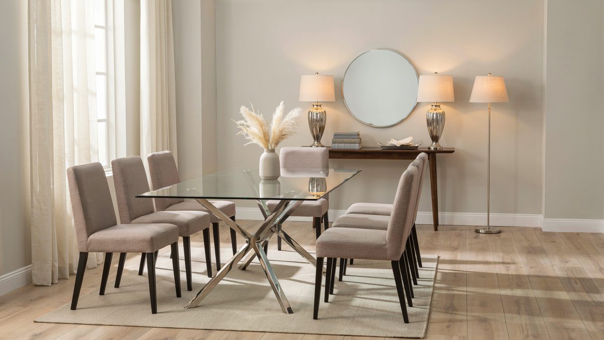 Glass top table on a chrome x base with taupe upholstered chairs