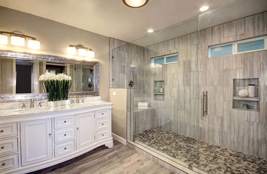 Large shower with glazed tile and bench