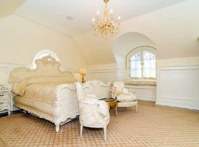 French colonial attic bedroom with chandelier