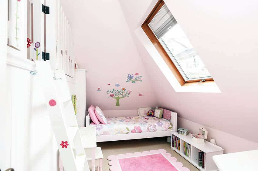 Girls attic bedroom with wall mural