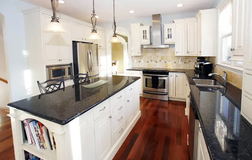 Kitchen with jatoba wood floors and white cabinets with black granite