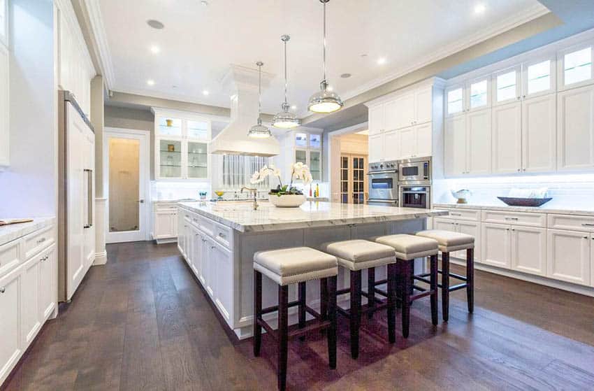 Luxury kitchen with white cabinets and wide plank oak wood floors