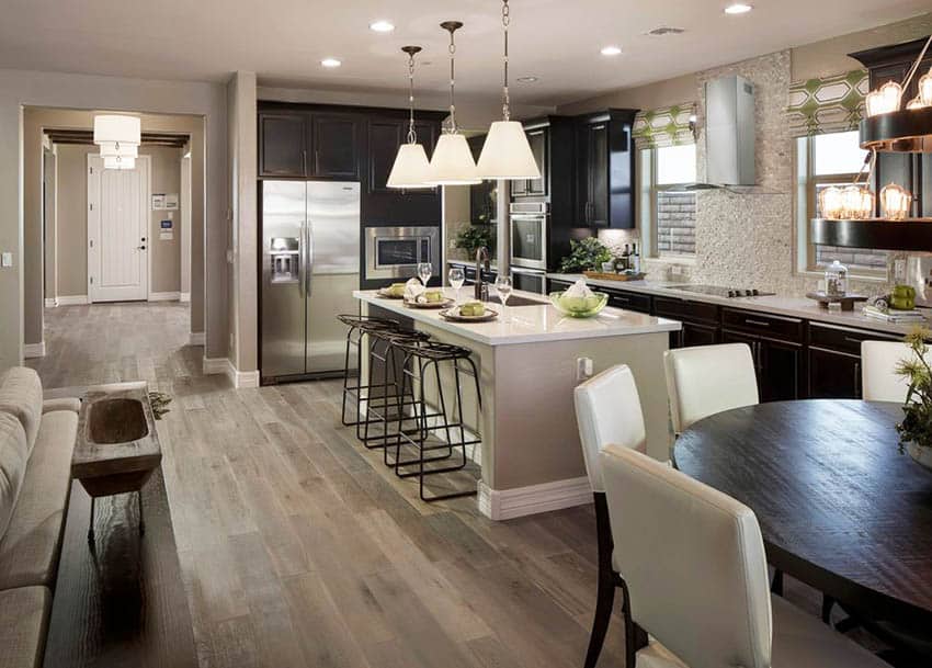 Dark Cabinet kitchen with wide plank white oak flooring and white quartz countertops