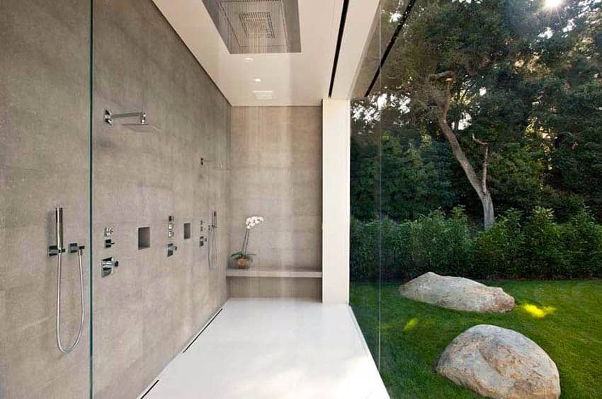 Large shower with outdoor view and rainfall feature