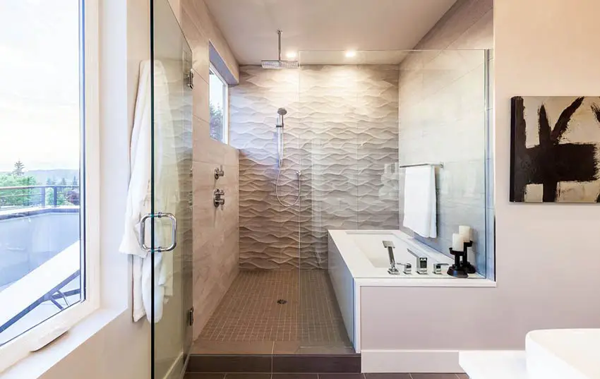 Bathroom with textured tiles and white tub