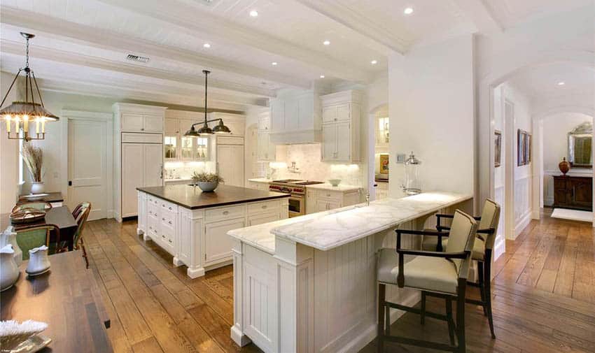 Beautiful kitchen with distressed wood flooring and white cabinets