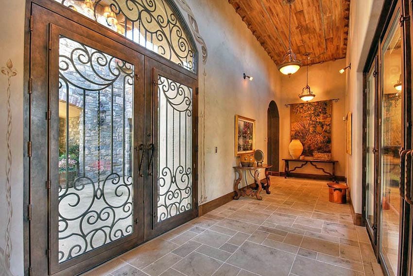 Mediterranean home with custom wrought iron french doors