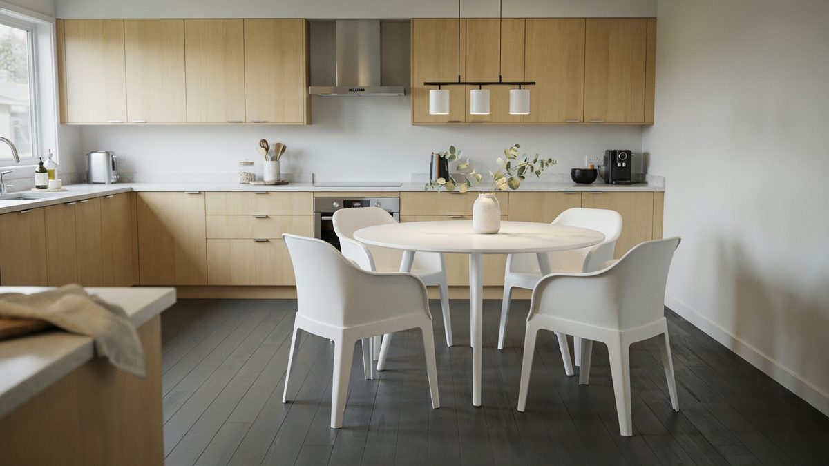Round white table with molded armchairs in a light oak galley kitchen