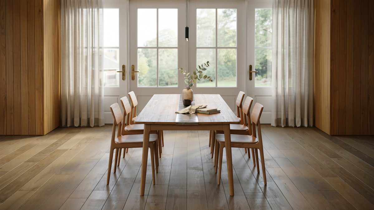 Long oak table with a steel runner facing tall white french doors
