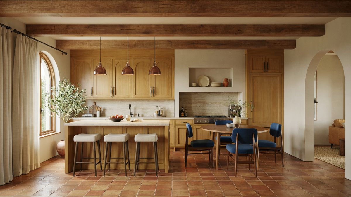 Open plan kitchen with oak cabinets, ceiling beams, and blue dining chairs