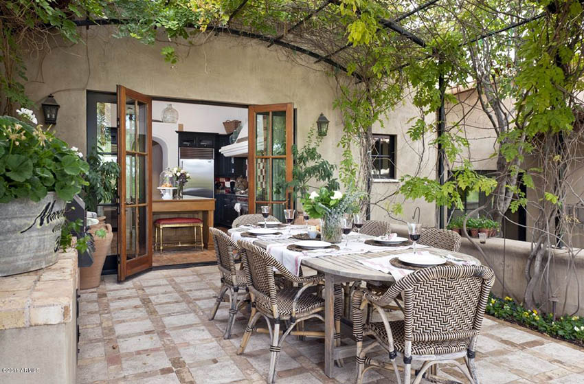 Patio with wood exterior doors and outdoor dining table