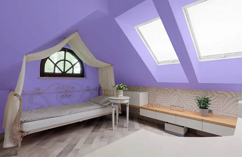 Purple attic bedroom with canopy bed