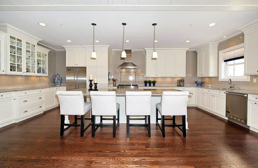 Red oak floors in white kitchen with shaker style cabinets and island