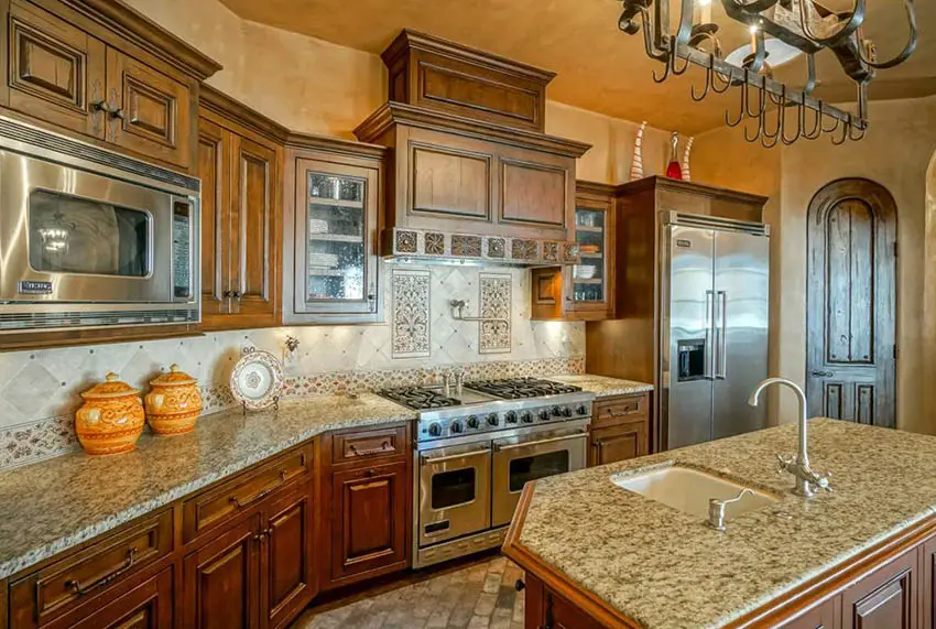 Kitchen with viking appliances, decorative backsplash and counter with sink