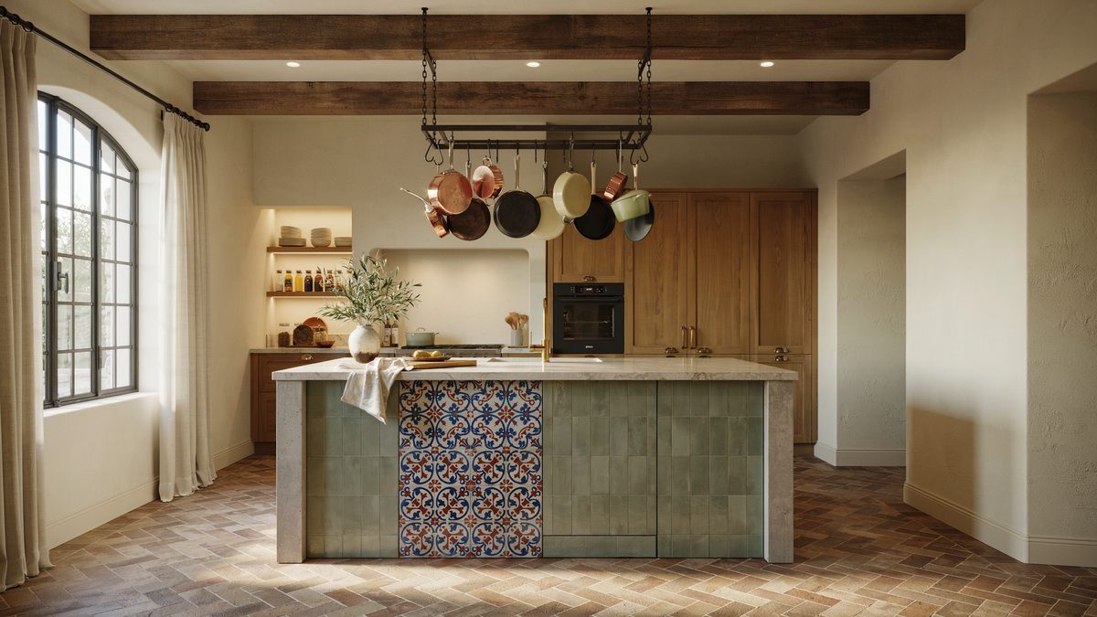 Island clad in sage green tile with walnut cabinets and overhead pot rack