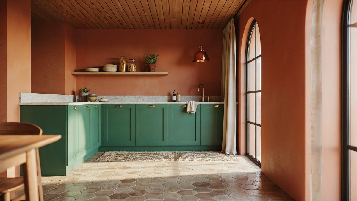 Emerald green paneled cabinets and hexagonal terracotta floors under a teak slat ceiling