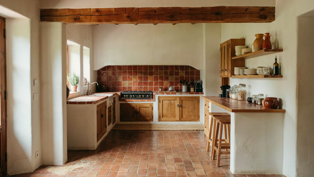 Red terracotta tile countertops and matching range hood cover with a breakfast bar