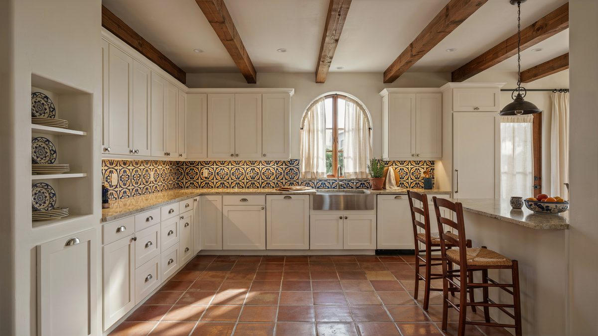 White paneled cabinets with beige granite counters below dark teak ceiling beams