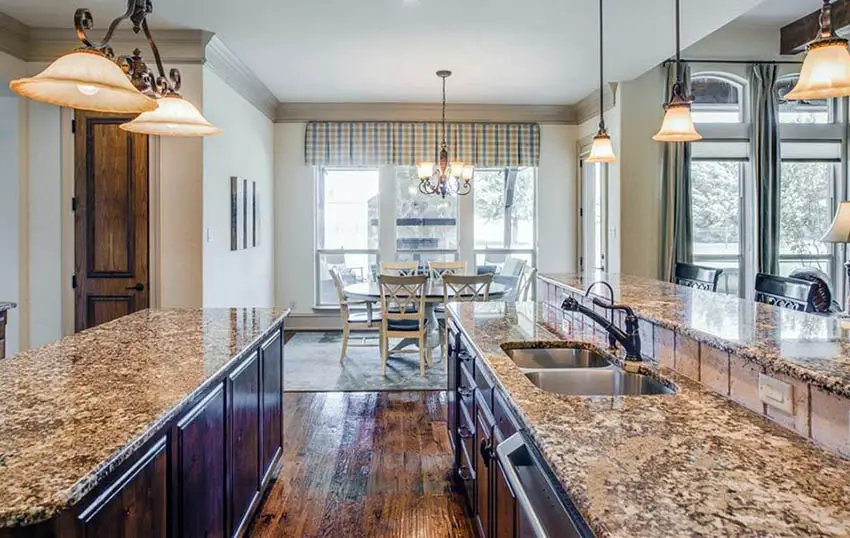 Traditional kitchen with straight neck faucet granite countertops and breakfast bar island