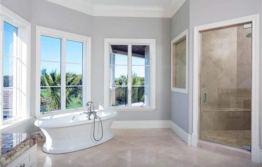 Bathroom with steam shower and pedestal bathtub