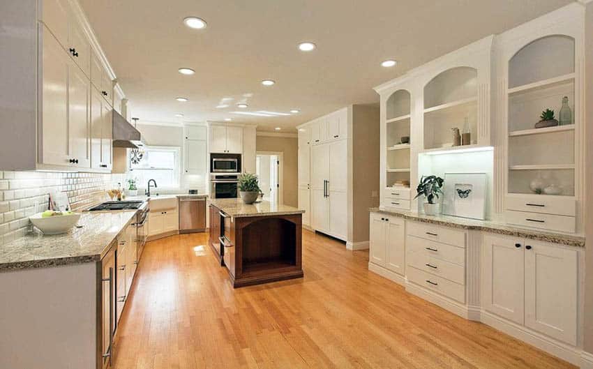 White kitchen with wood strip flooring