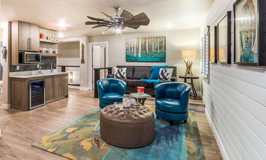 Basement wet bar with laminate flooring and shiplap walls