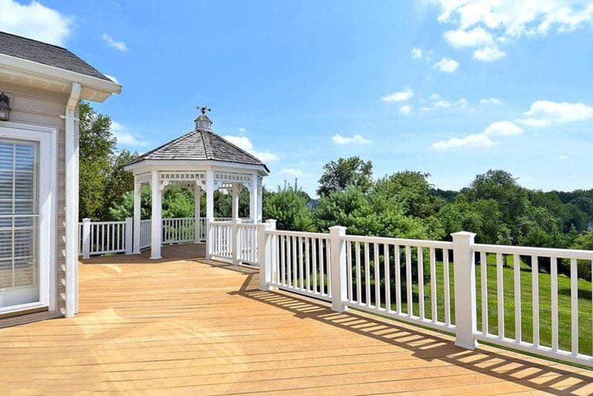 Colonial deck with white railings and gazebo
