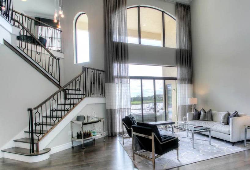 Contemporary living room with modern wrought iron staircase with design supports