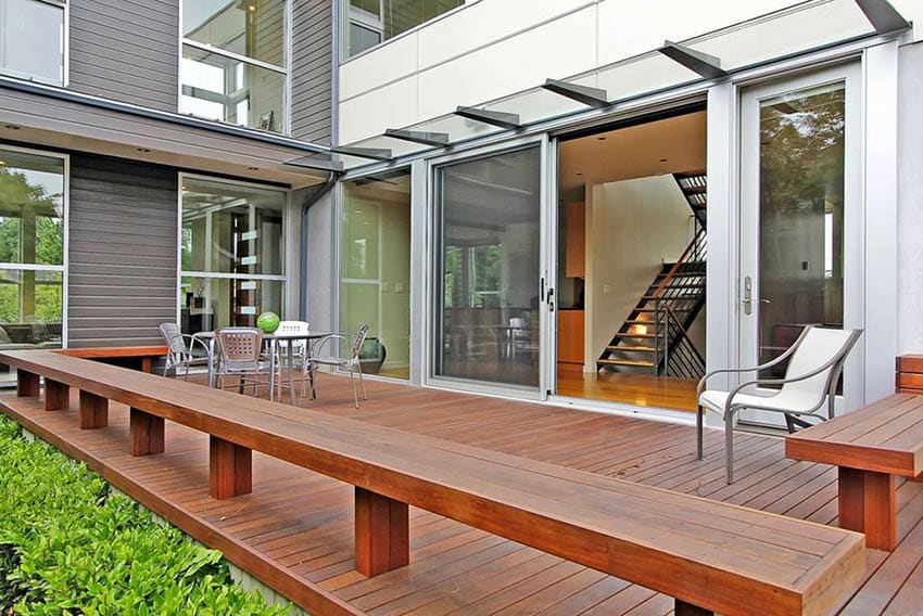 Contemporary wood deck with french doors and sitting benches
