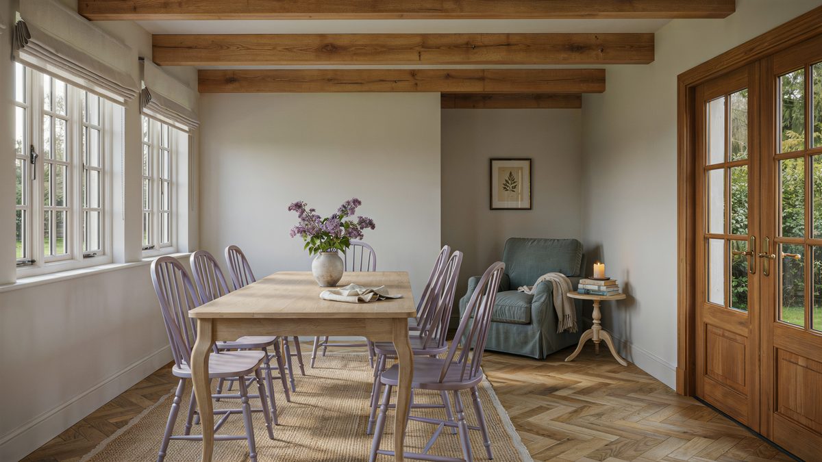 Lilac Chippendale chairs and a sage reading chair under exposed ceiling beams