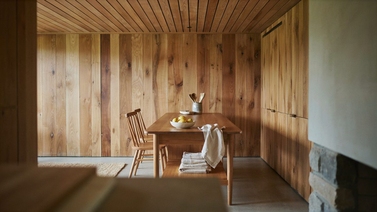 Teak portable island with open shelf under a wood slat ceiling