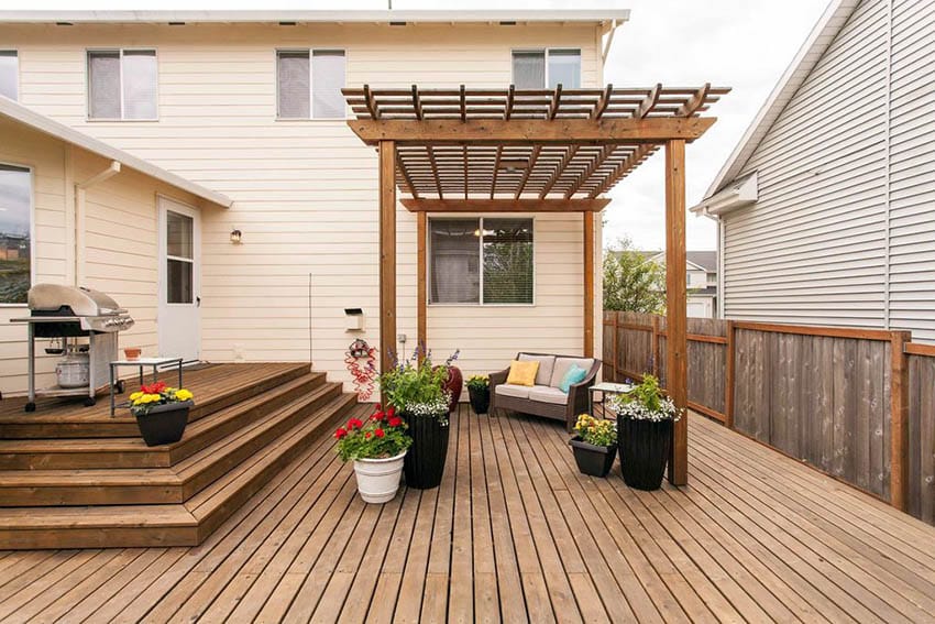 Custom deck design with steps up to house and pergola