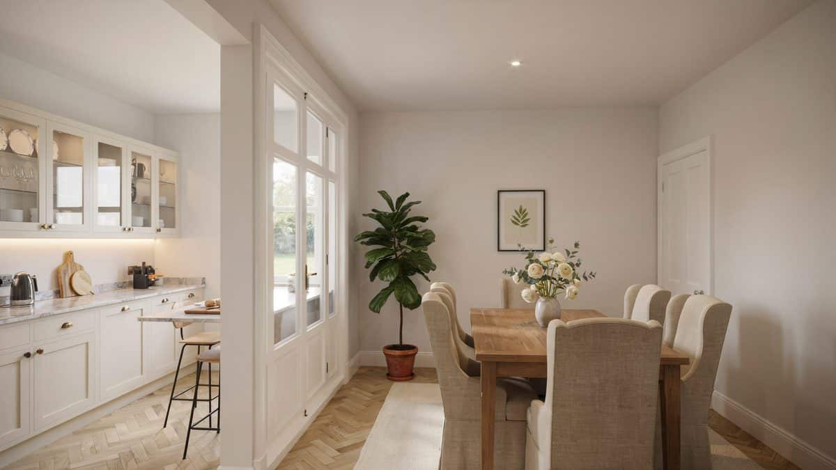 Beige wingback chairs at an oak table beside glass front kitchen cabinets