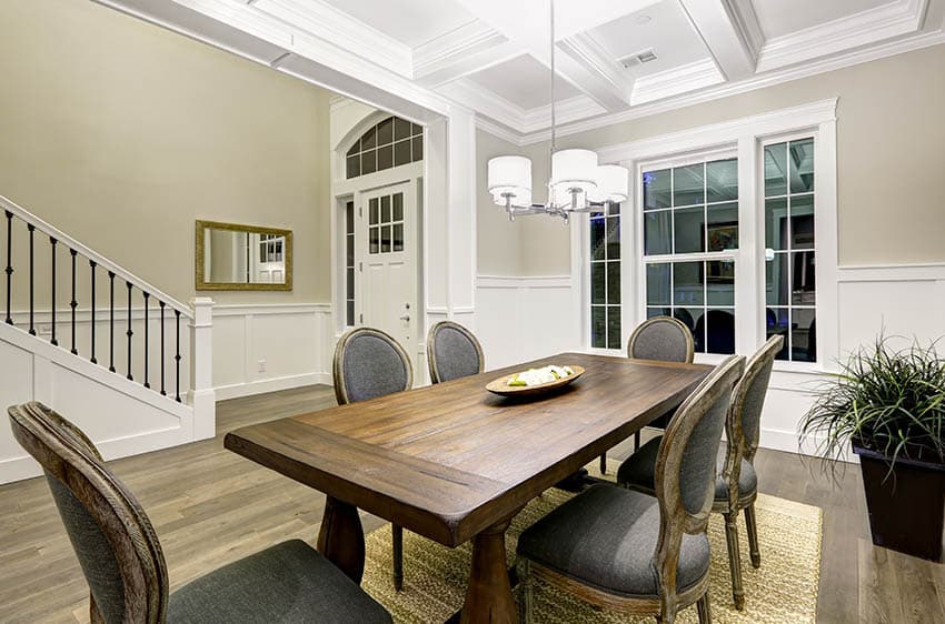 Dining room with white staircase railing and black metal supports