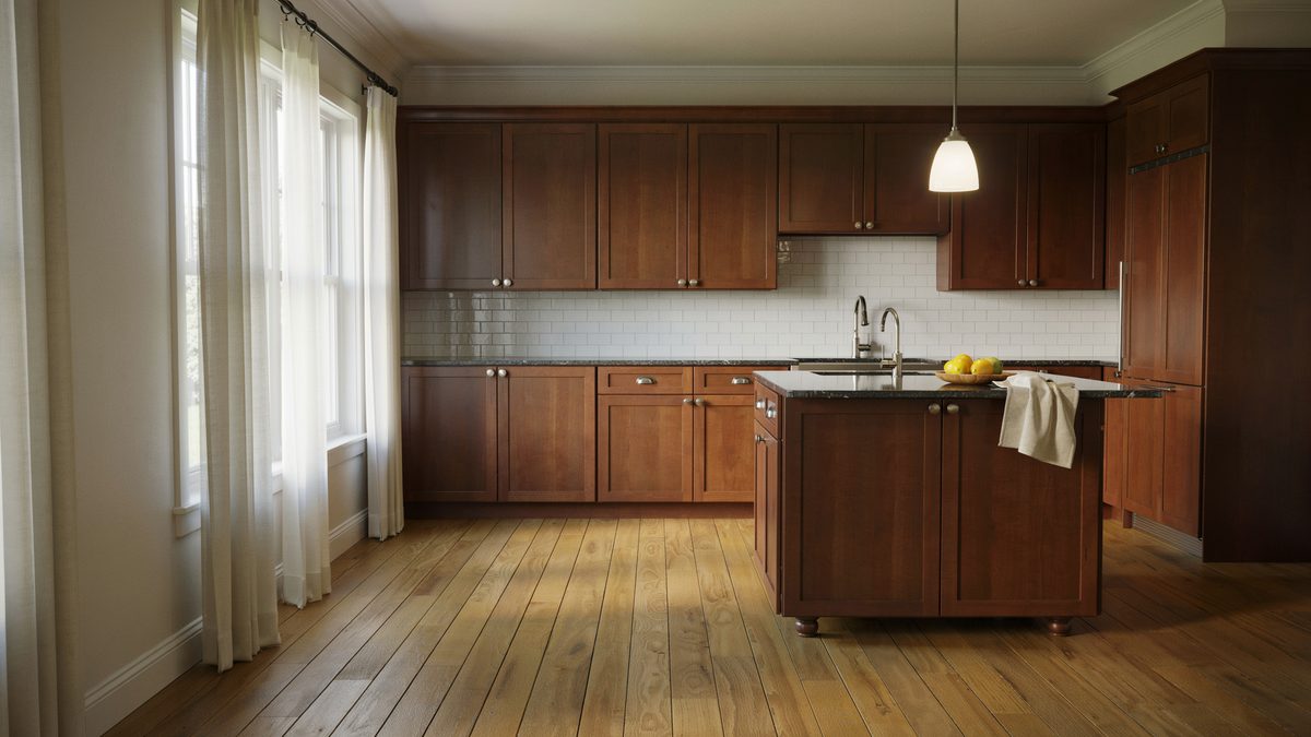Dark wood island with granite top among full height cabinets