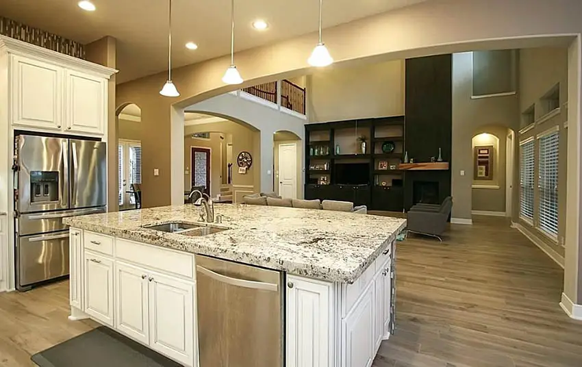 Kitchen with dark floor boards and light color granite counters