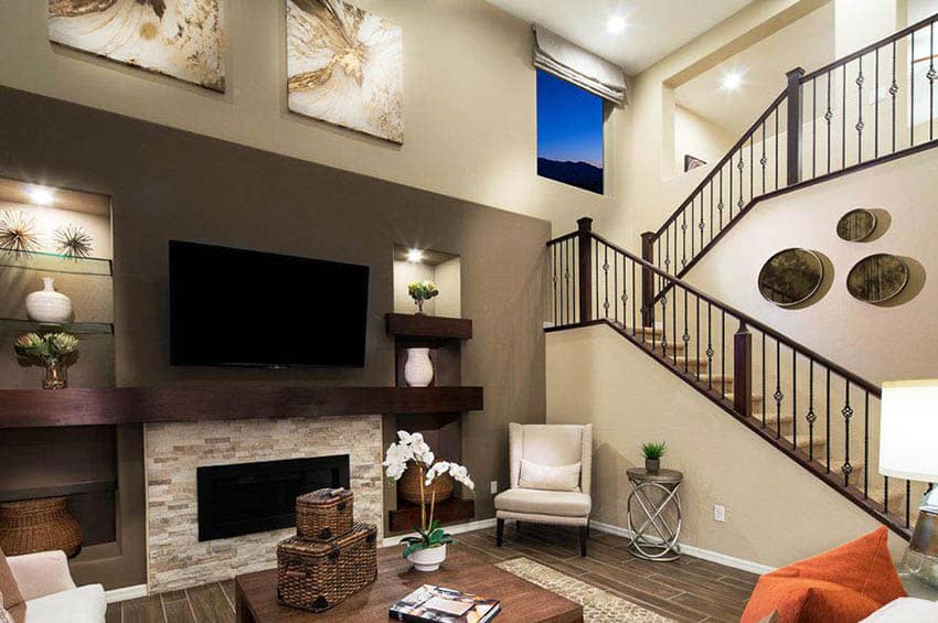 Living area with white brick fireplace, grey accent wall and wood balusters