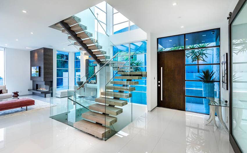 Modern house with floating wood stairs and glass railing