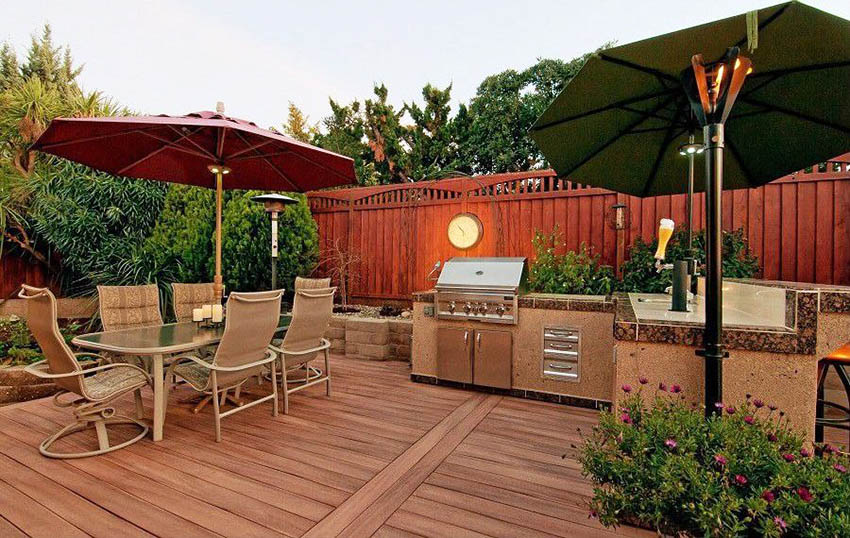 Modern trex deck with outdoor kitchen and dining table