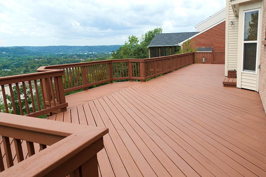 Painted wood deck with railing and hillside views