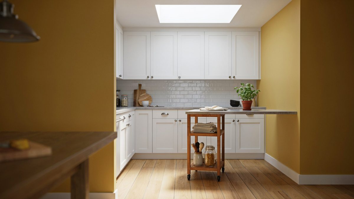 Pine storage cart in a kitchen with white cabinets and skylight