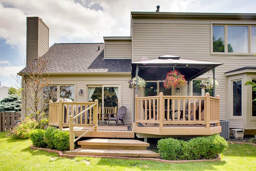 Raised deck with railings and portable canopy