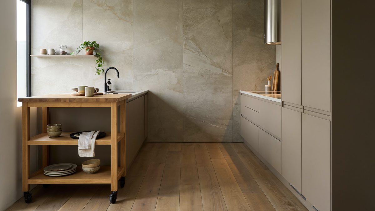 Maple rolling island on casters beside a stone clad kitchen wall