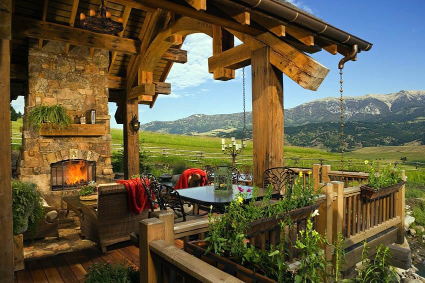 Rustic mountain style deck with stone outdoor fireplace