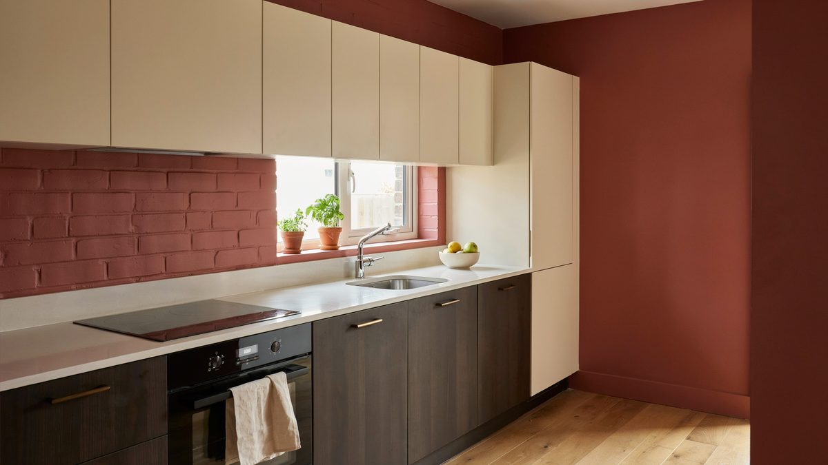 Red walled kitchen with cream upper cabinets and dark wenge lower cabinets