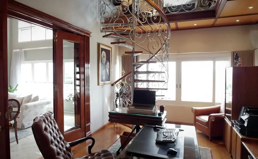 Staircase in the den with leather office chair and glass sliding doors